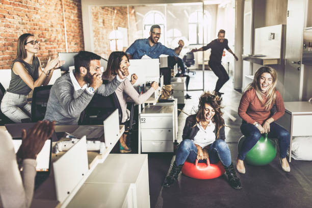 istock Joyful business colleagues having fun in space hopper challenge at casual office. 1142800900