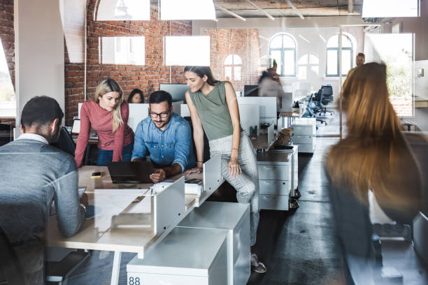 istock Working on laptop at busy corporate office! 1142801079