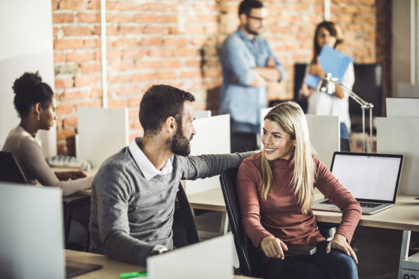 istock Young happy colleagues talking at corporate office. 1142801203