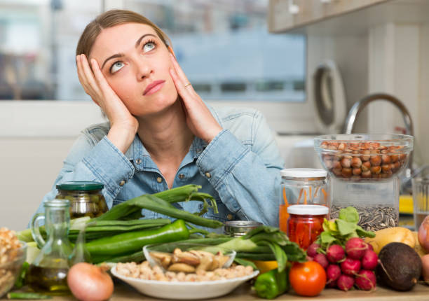 istock Upset woman sitting at home kitchen 1142802225