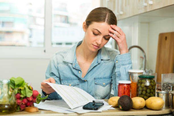 istock Woman counting money for paying bills at kitchen 1142802229