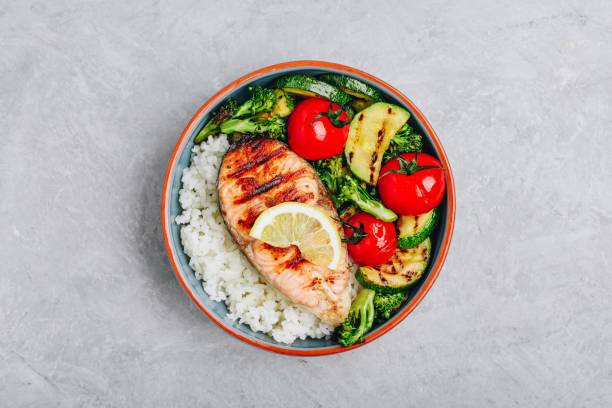 istock Grilled salmon steak with and rice, zucchini, broccoli, tomato . 1142802718