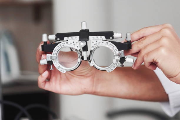 istock Focused photo. Female hands holding the optical device for eye testing 1142803344