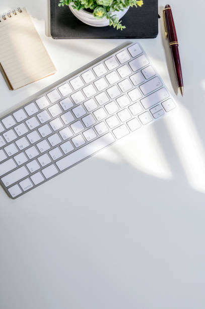 istock Mockup white keyboard and supplies on white table, copy space for text or product dispaly. 1142803463