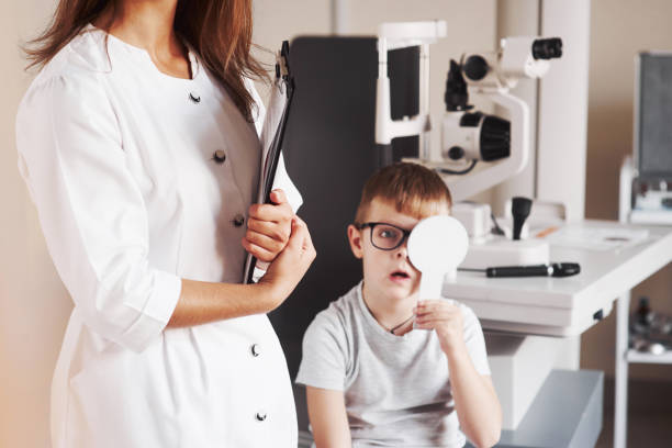 istock He is shocked that he can read those words. Woman with documents tests the visual acuity of a little boy 1142803544