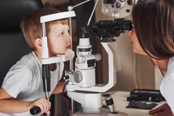 istock This might take one more minute. Little boy have test for his eyes with special optical apparatus by female doctor 1142803732
