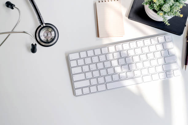istock Mockup stethoscope with white keyboard and supplies on white table, copy space for text or product dispaly. 1142803806