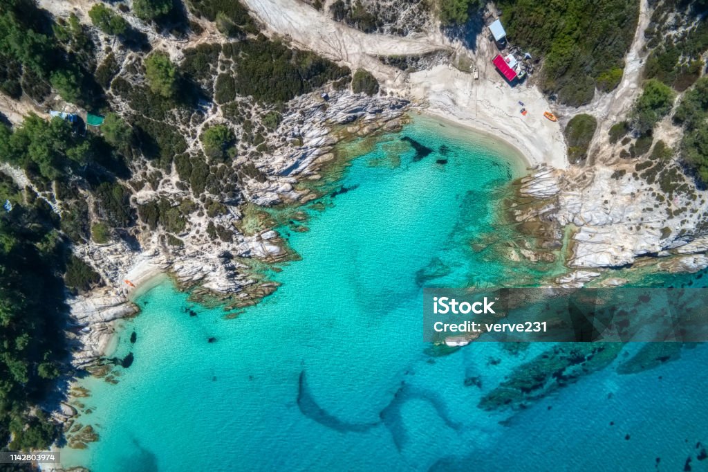 Kavourotripes or Orange is a small paradise of small beaches Kavourotrypes or Orange is a small paradise of small beaches located between Armenistis and Platanitsi in Sithonia, Chalkidiki, Greece Aerial View Stock Photo