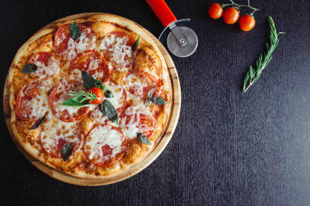 istock Italian Pizza on the Board in the dark table 1142804139
