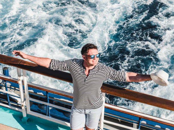 istock Smiling man on the empty deck of a liner 1142805005