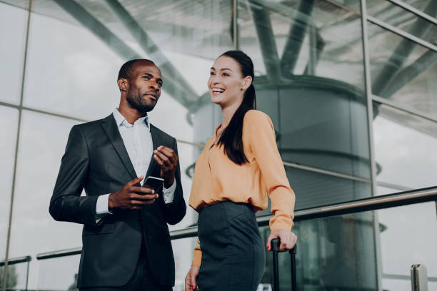 istock Two business partners talking while standing at the airport 1142805099