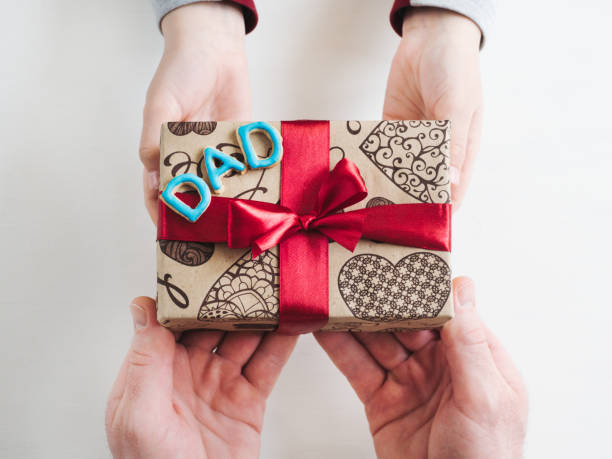 istock Child's hands and a beautiful gift box, 1142805113