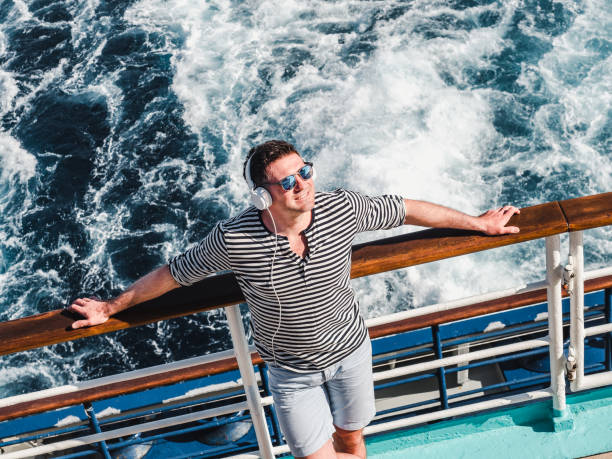 istock Smiling man listening to music on the empty deck 1142805321