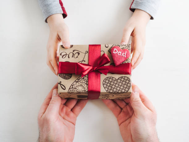 Child's hands and a beautiful gift box,