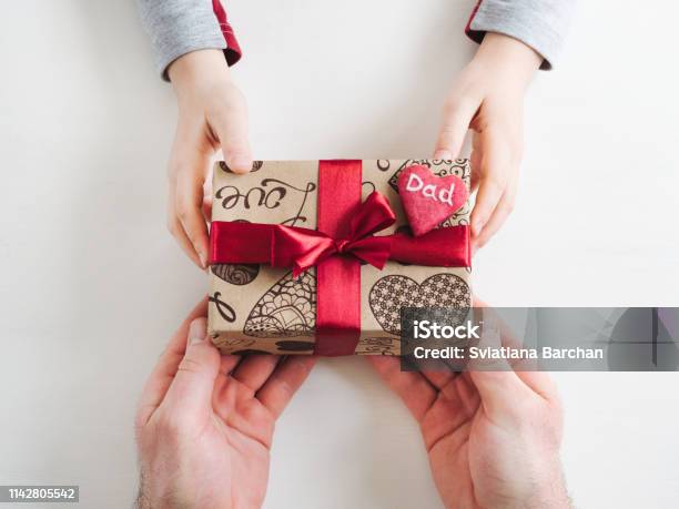Childs Hands And A Beautiful Gift Box Stock Photo - Download Image Now - Gift, Father, Father's Day