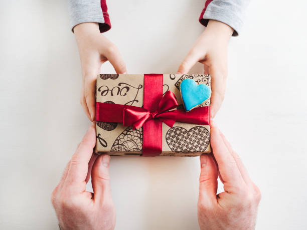 istock Child's hands and a beautiful gift box, 1142805665