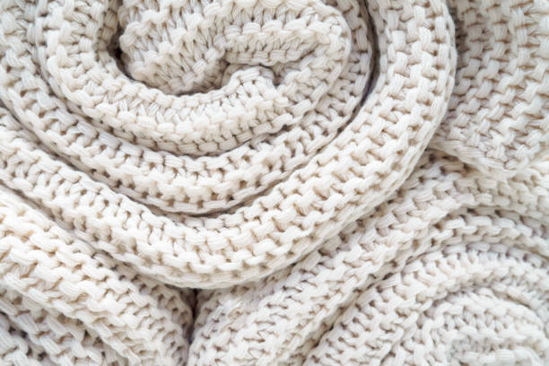 istock close-up of roll white knitted plaid, soft selective focus 1142805841