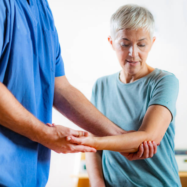 istock Therapist Checking Senior Woman’s Arm 1142806624
