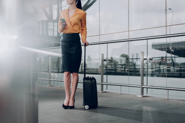 istock Brunette woman with suitcase is waiting for flight 1142807076