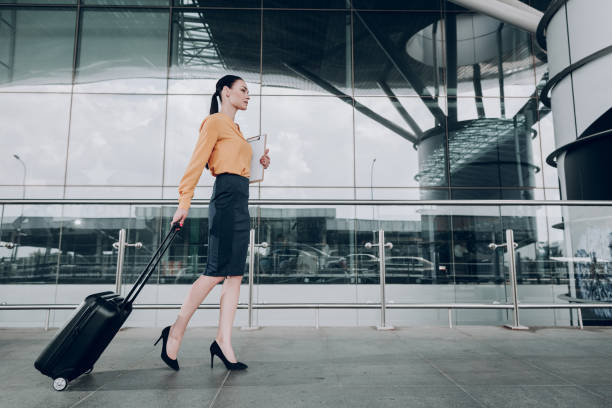 istock Business lady with suitcase is holding writing folder 1142807080