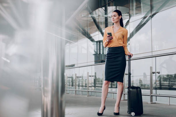 istock Pretty brunette woman with baggage is waiting 1142807082
