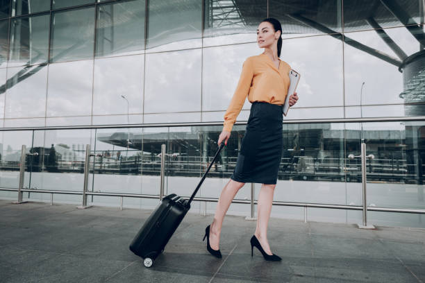 istock Pretty brunette woman is walking near office 1142807084