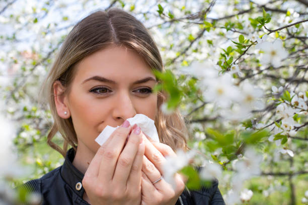 istock Allergic woman sneezing outdoor on springtime 1142807338