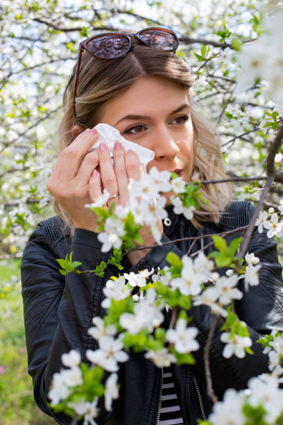 istock Allergic woman sneezing outdoor on springtime 1142807441