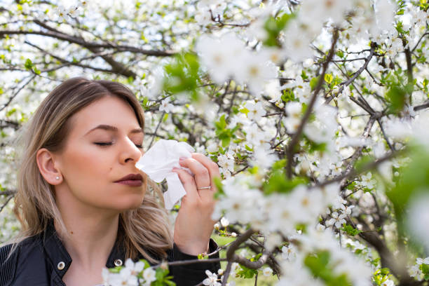 istock Allergic woman sneezing outdoor on springtime 1142807520