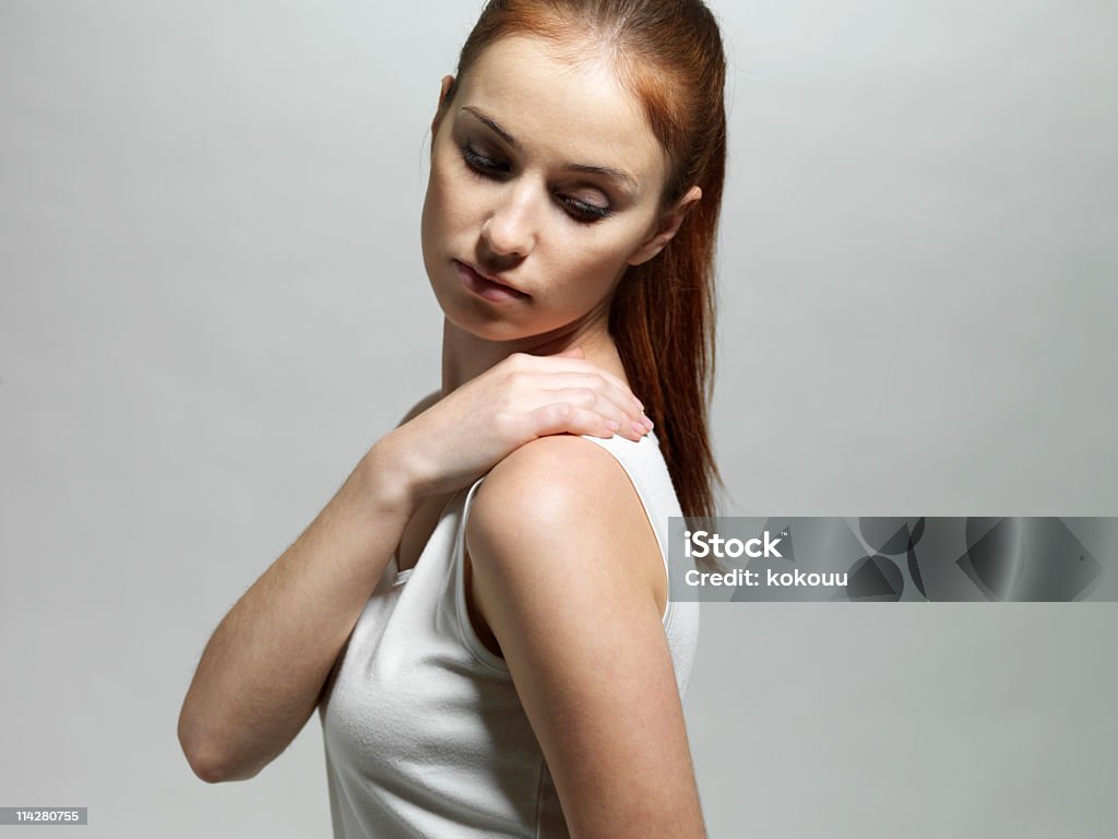 Young woman with a shoulder massage The young woman with a shoulder massage. Stiff Shoulder Stock Photo