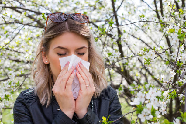 istock Allergic woman sneezing outdoor on springtime 1142807602