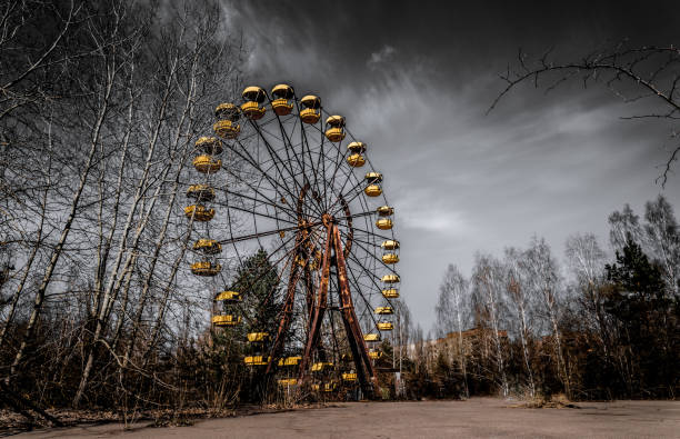 Old ferris wheel in the ghost town of Pripyat. Consequences of the accident at the Chernobil nuclear power plant Famous landmark of the abandoned city of Pripyat, Ukraine. Old rusty ferris wheel. Desolation and devastation in the exclusion zone after a nuclear explosion at the Chernobyl nuclear power plant chornobyl photos stock pictures, royalty-free photos & images