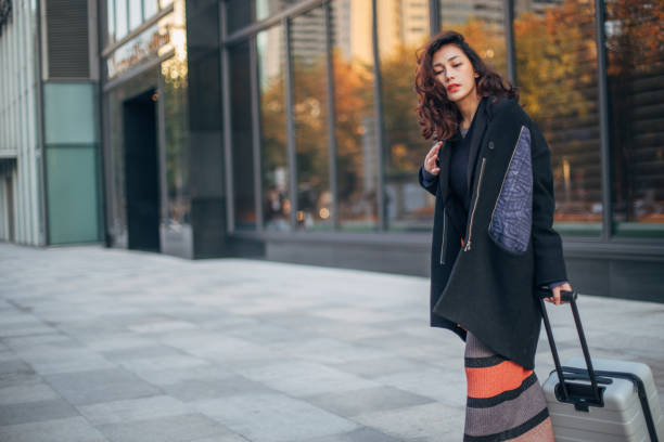 istock Lady with luggage on the street 1142808596