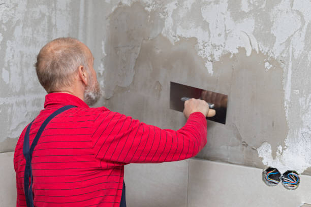 istock Elderly craftsman working with tiles 1142808785
