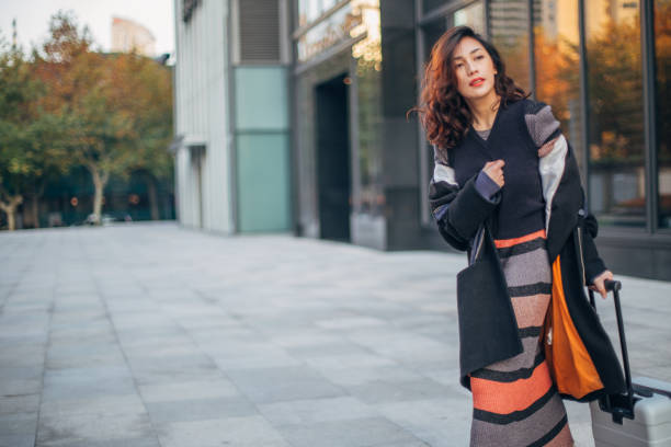istock Woman with luggage waiting for a ride 1142808827