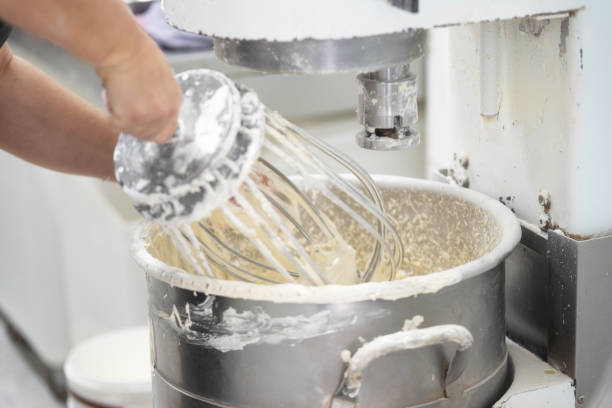 istock kneading dough in bakery dough mixer machine. 1142809937