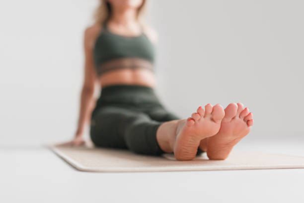istock Blurred female sitting on yoga mat 1142811691