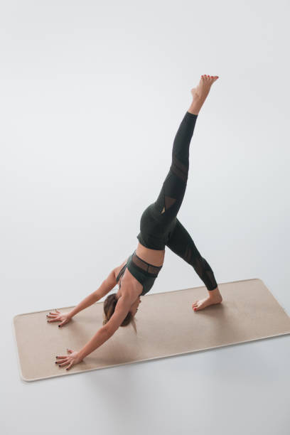 istock Woman practicing yoga asana on mat 1142811718
