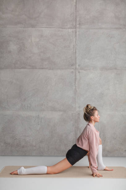 istock Young female in Lunge on Knee pose 1142811724