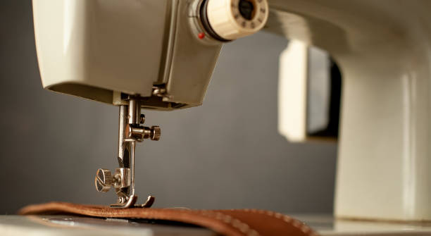 istock Background type of sewing machine, leather belt sewing process. Leather workshop. 1142813579