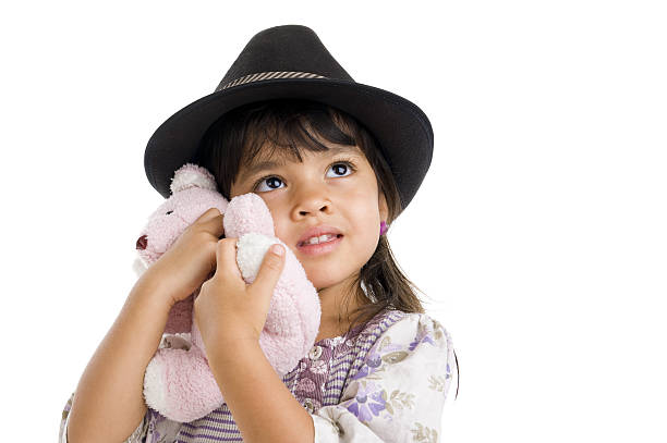 Hands holding teddy bear in dark room