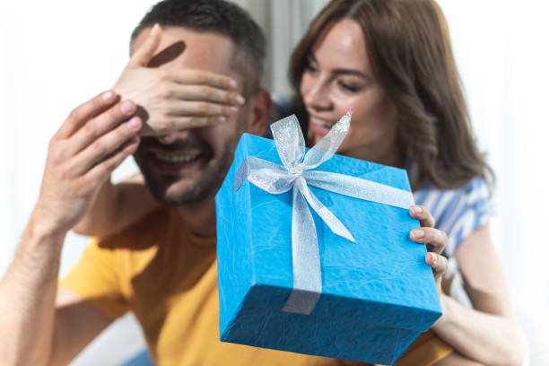 istock Pretty wife is preparing beautiful gift for her husband 1142815616