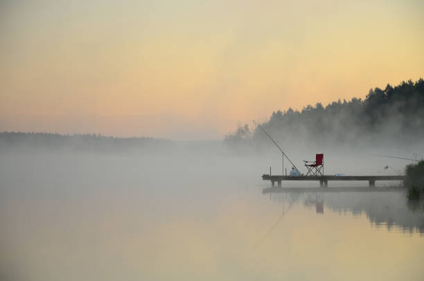 Fishermen wait for a fish on a beautiful misty morning