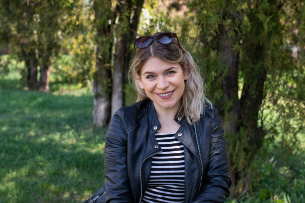 istock Woman sitting in the park 1142816074
