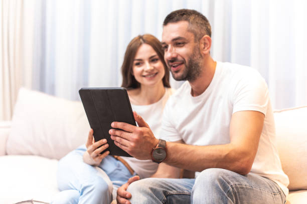 istock Cheerful twosome spending time together on couch 1142817444