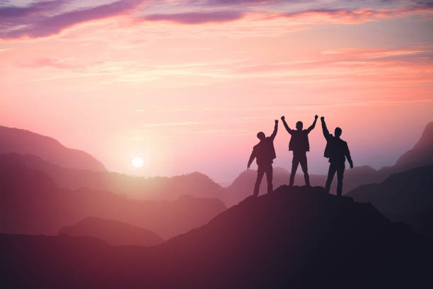 istock three guys celebrating victory on top of a mountain 1142818868