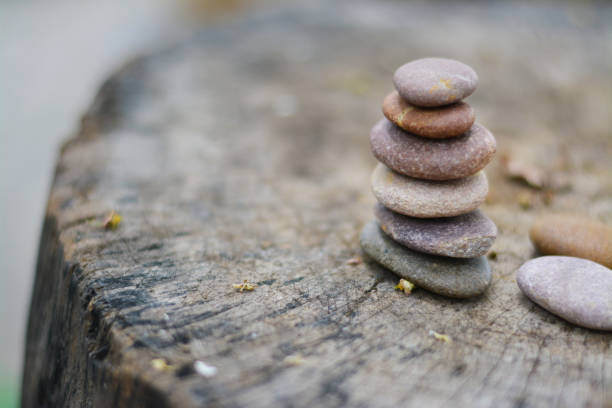 istock Six zen stones put on grey timber with two stones left space position. 1142820349