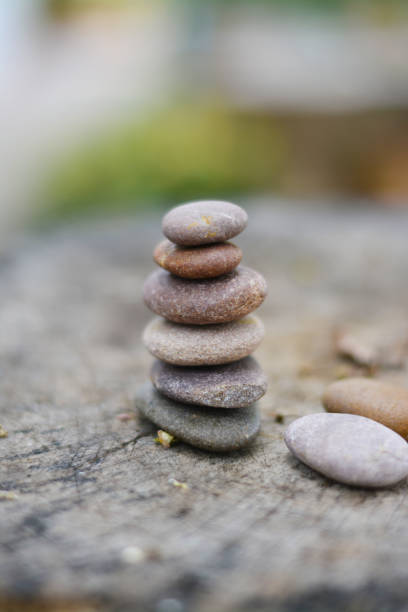 istock Six zen stones put on grey timber with two stones vertical position. 1142820357