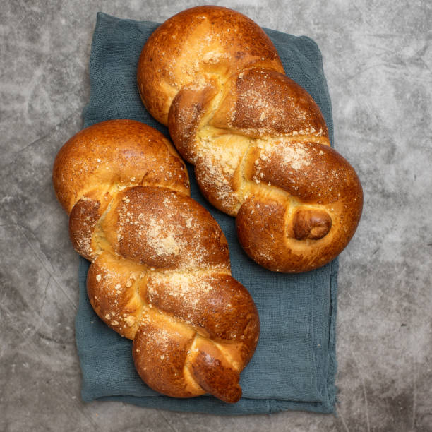 istock Shabbat Shalom - challah bread on grey background. Top view 1142820451