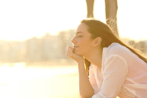 istock Relaxed woman enjoying sunset on the beach 1142821316